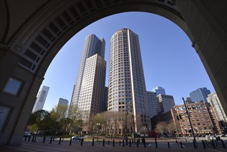 View through the arch of Rowes Wharf at skyscrapers of One International Place
