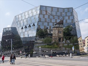 The building of the university library and the reflection on the glass facade of the building