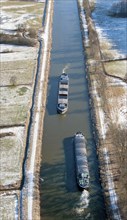 Aerial view of two barges in the Elbe Luebeck Canal in winter