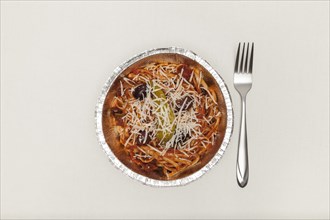 Fork and aluminium plate with noodles