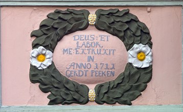 Ornament and inscription on an old dwelling house in Jever from 1711