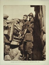 Officers in trench at observation post watching the battlefield at Merkem in Flanders during the First World War