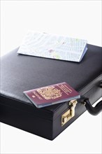 Business persons briefcase with UK passport and street map