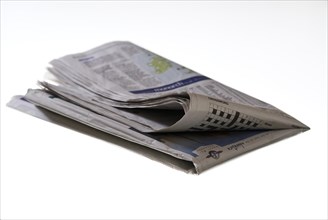Folded newspaper on white background