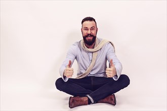 Man sitting cross-legged and casually dressed