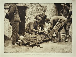 Arrival of wounded soldier on stretcher at first aid post in Flanders during the First World War