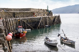 Fishing boats safely moored behind the protection of harbour wall