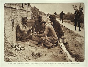 Soldiers checking the pins in hand grenades in Flanders during the First World War
