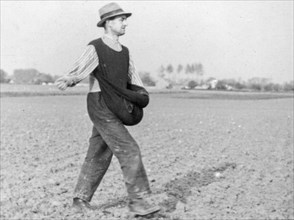 Old historical photograph showing farmer