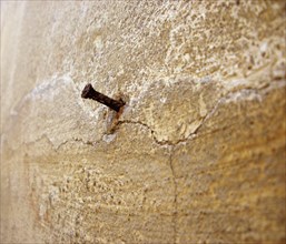 Rusty nail in wall