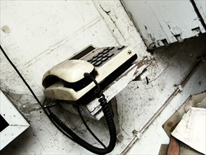 Old push-button telephone in demolition house