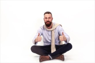 Man sitting cross-legged and casually dressed