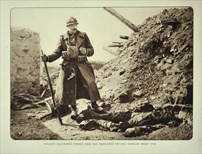 Belgian soldier looking at dead German soldier killed in action in trench at Diksmuide in Flanders