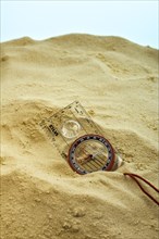 Compass buried in sand