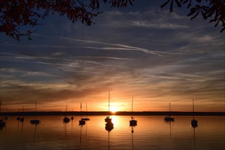Sailing boats in the sunset in Herrschinger Bucht on Lake Lake Ammer