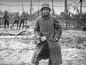 WWI German prisoner of war behind barbed wire of POW camp at Langemarck