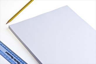 Blank pad of white paper with a pencil and plastic ruler