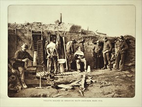 Soldiers getting shaved by barber in trench in Flanders during the First World War