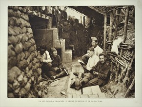 Soldiers resting and reading books at shelter in trench in Flanders during the First World War