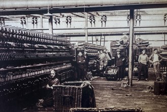 Old early twentieth century archival picture of child labourers working in the textile industry