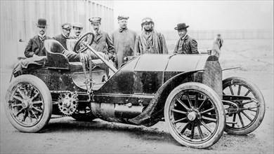 Old archival black and white photograph showing factory-backed driver