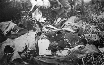 Old black and white photograph of decaying dead body