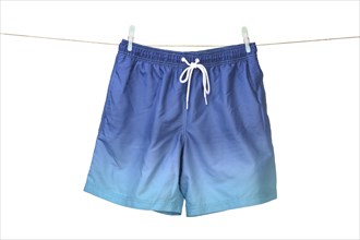 Swim shorts hanging on a washing line