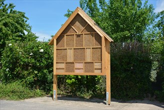 Big wood insect house hotel structure created to provide shelter for insects like bees to prevent extinction