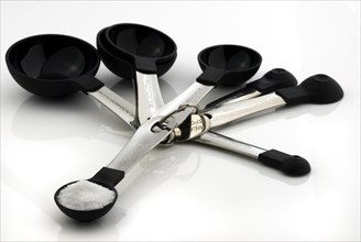 Group of measuring spoons with salt
