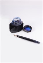 Bottle of ink with fountain pen