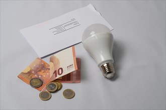 Light bulb and money energy saving concept