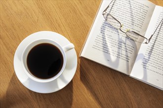 Coffee cup book and glasses from above