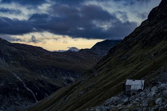 Tschierva hut above Val Rosegg and Engadine mountains at blue hour