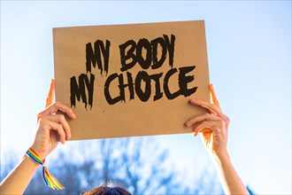 A woman holding a sign in favor of the legalization of abortion