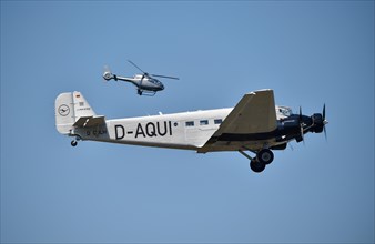 Propeller plane Ju 52 and helicopter flying over Hesse