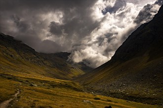 Val Minor in autumn colours with dramatic cloudy sky