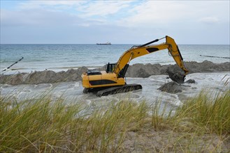 Excavators working on the coastal protection near Ahrenshoop on the Baltic Sea
