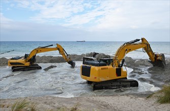 Excavators working on the coastal protection near Ahrenshoop on the Baltic Sea