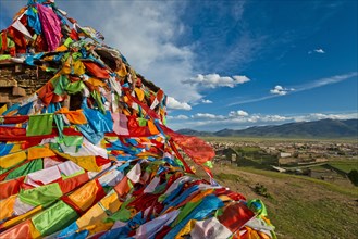 Prayer flags near Litang Tibetan Buddhist Monastery overlooking the town
