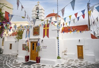 Cycladic Greek Orthodox Church decorated with flags