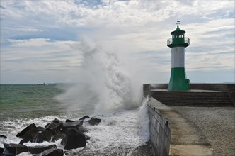 Waves splash against the pier of Sassnitz lighthouse