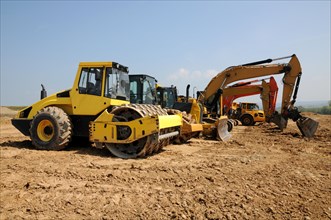 Excavators and bulldozers working on large construction site