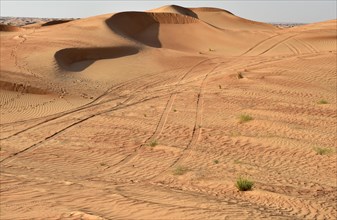 Car tracks in the sand desert near Dubai
