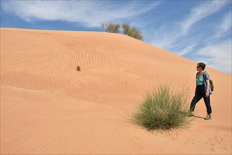 Woman in the sand desert near Dubai