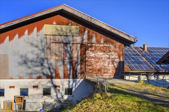 Tin barrel and solar panel on a farm