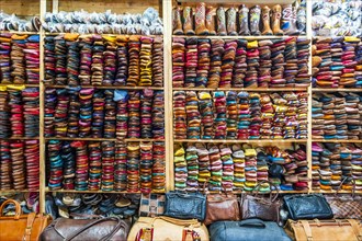 Colorful handmade leather slippers waiting for clients at shop in Fes