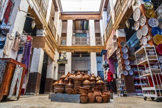 Shop in the courtyard with traditional tajine pot in the middle