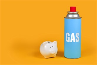 Gas cartridge bottle with piggy bank on yellow background