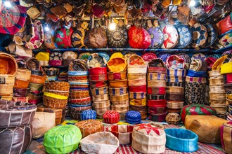Variety of leather poufs sold in huge shop next to tannery in Fes