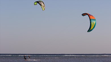 Two kitesurfers